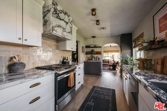 a kitchen with a stove and cabinets