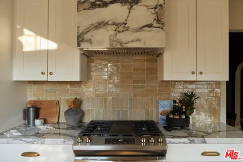 a kitchen with cabinets and stainless steel appliances