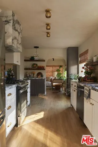 a kitchen with counter top space and living room