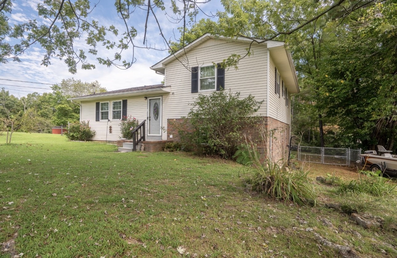 a front view of house with yard and outdoor seating