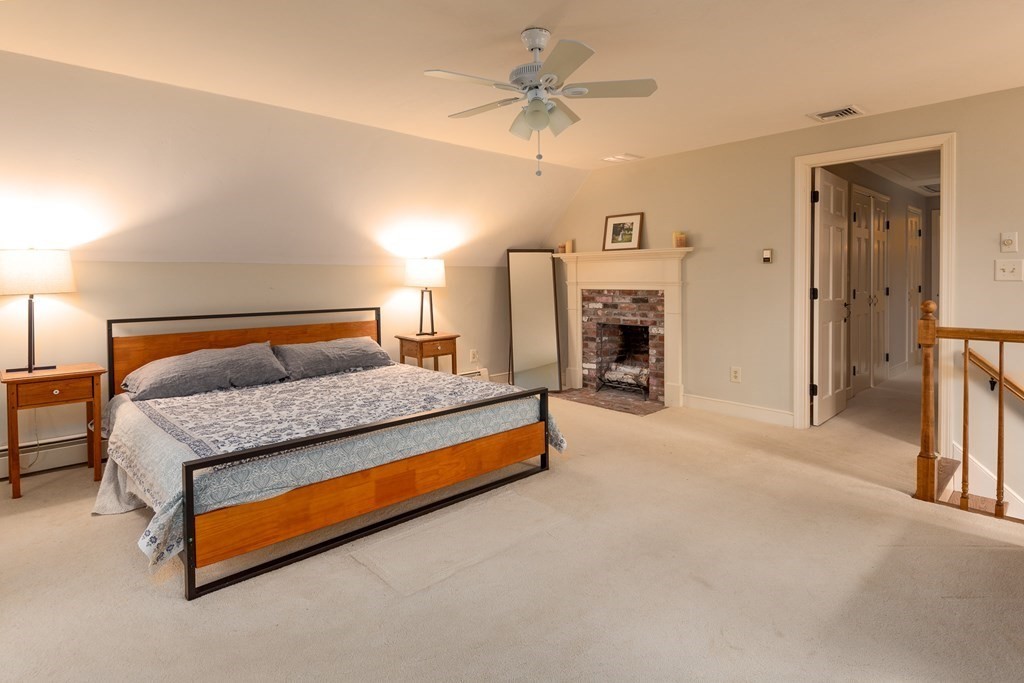170 Saddle Hill Road Hopkinton, MA 01748 - Photo 18 of 31 a bedroom with a bed and a fireplace