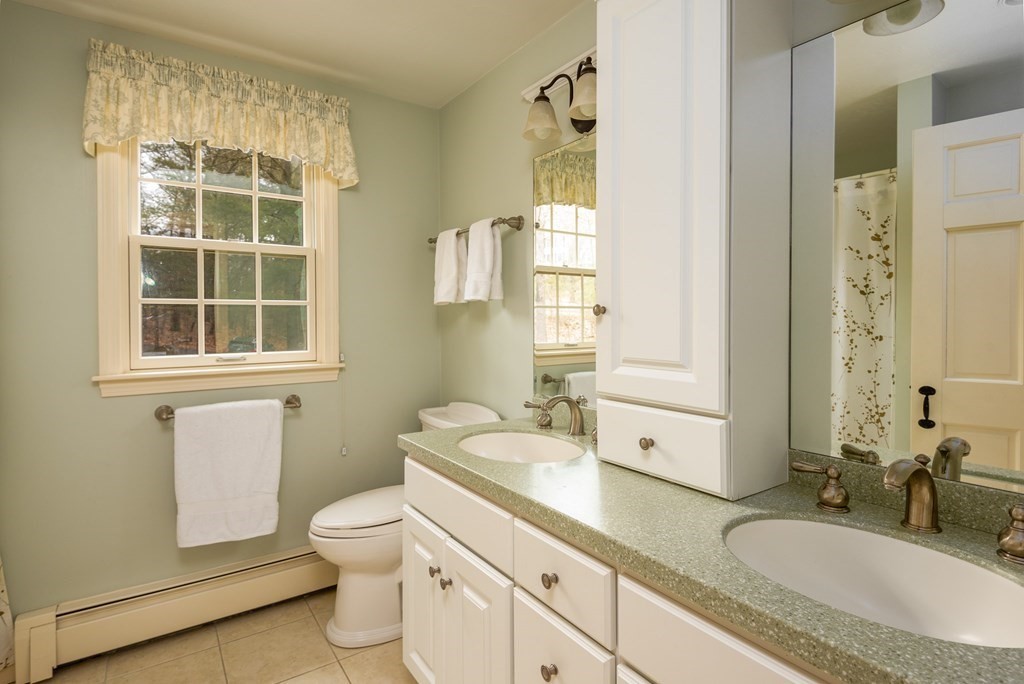 170 Saddle Hill Road Hopkinton, MA 01748 - Photo 25 of 31 a bathroom with a granite countertop toilet a sink and a mirror