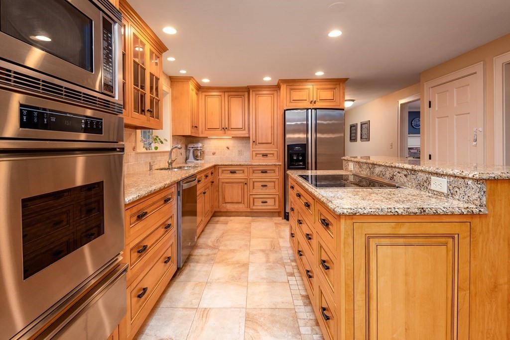 170 Saddle Hill Road Hopkinton, MA 01748 - Photo 4 of 31 a large kitchen with granite countertop a stove and cabinets