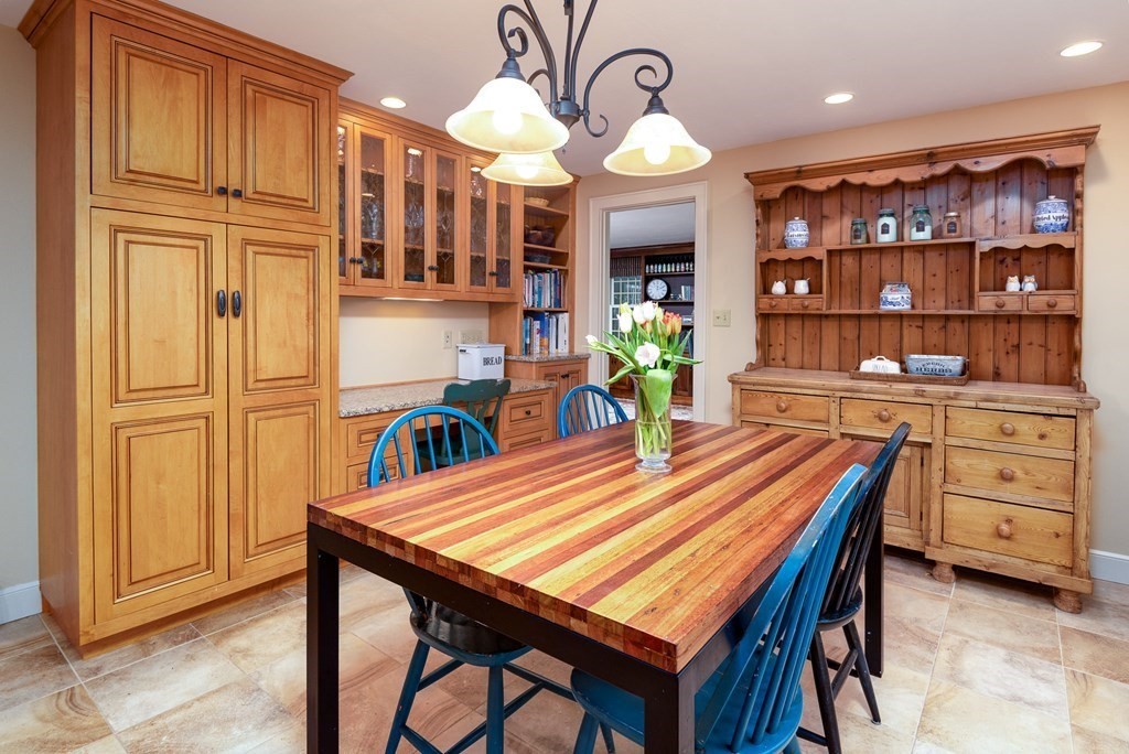170 Saddle Hill Road Hopkinton, MA 01748 - Photo 5 of 31 a dining room with a wooden table and chairs