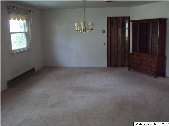 116 Sunset Road Whiting, NJ 08759 - Photo 11 of 21 an empty room with windows cabinet and chandelier