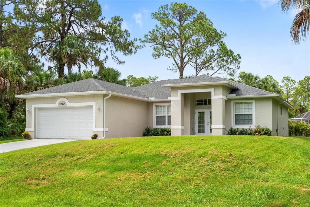 3222 Trapper Lane North Port, FL 34286 - Photo 1 of 1 a front view of house with yard and green space