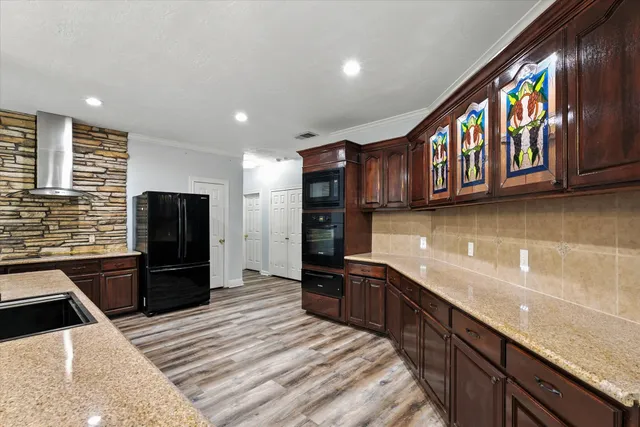 a kitchen with stainless steel appliances granite countertop a refrigerator and a sink