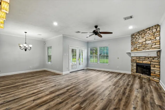 a view of an empty room with a fireplace and a window