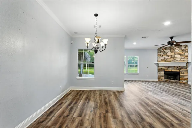 a view of livingroom with chandelier and fireplace
