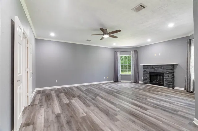 wooden floor in an empty room with a fireplace