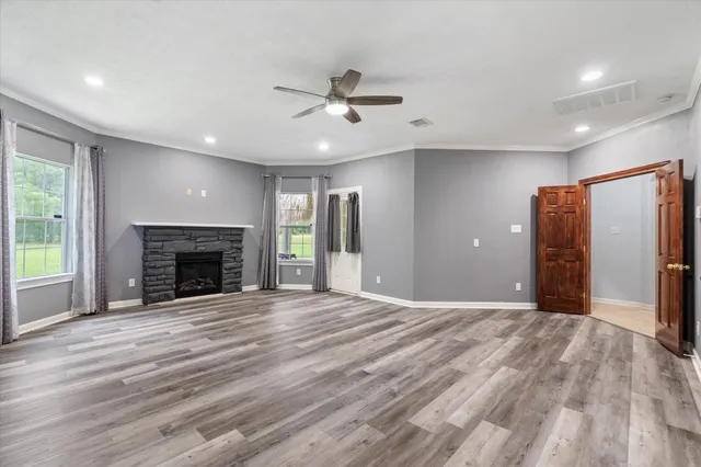 an empty room with windows and a fireplace