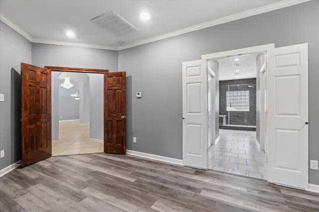 an empty room with wooden floor and closet