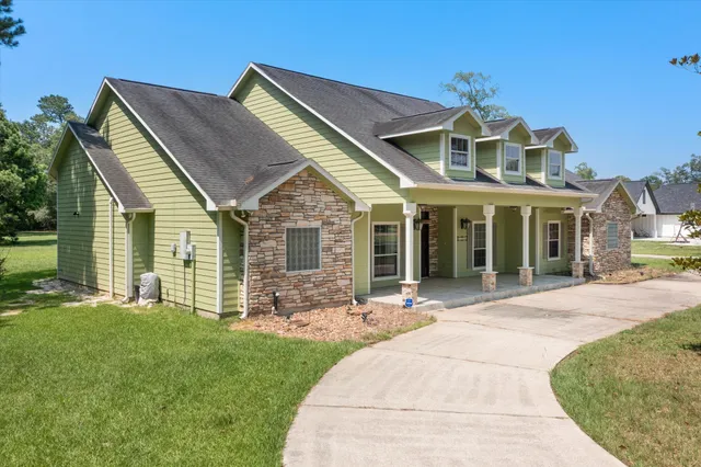 a front view of a house with a garden and yard