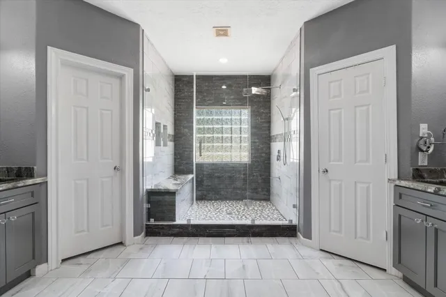 a view of a bathroom with tub shower and sink