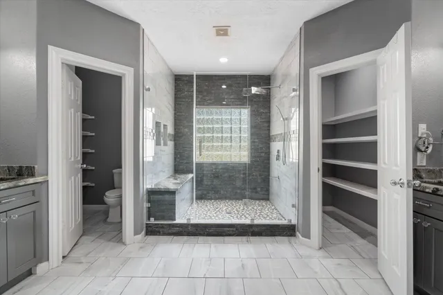 a bathroom with a shower and a sink