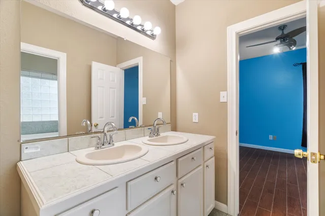 a bathroom with a sink double vanity and a mirror
