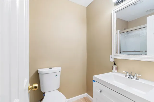 a white toilet sitting next to a bathroom sink