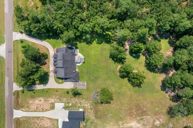 an aerial view of a house with a yard