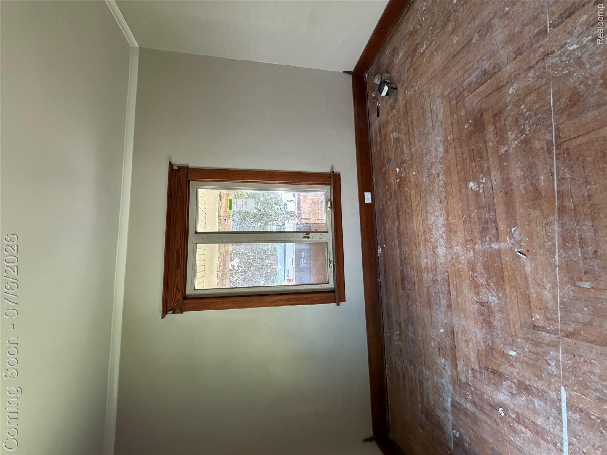 808 Division Street Owosso, MI 48867 - Photo 21 of 25 Room featuring a double-hung window with a wood frame and trim