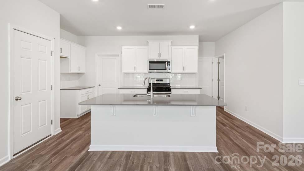 170 Old Home Road Statesville, NC 28677 - Photo 11 of 40 a kitchen with stainless steel appliances granite countertop a sink and cabinets