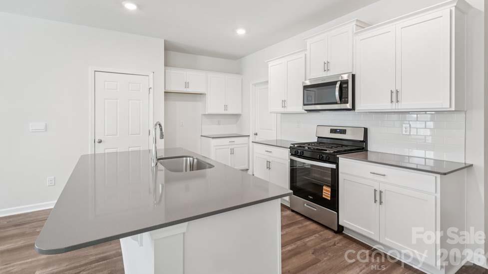 170 Old Home Road Statesville, NC 28677 - Photo 13 of 40 a kitchen with stainless steel appliances white cabinets and a sink