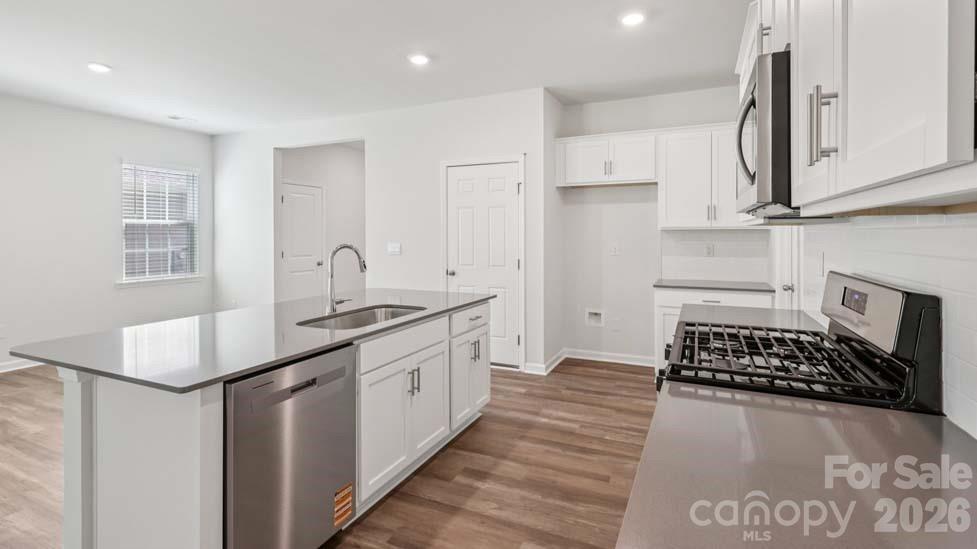 170 Old Home Road Statesville, NC 28677 - Photo 15 of 40 a kitchen with a sink stove and cabinets