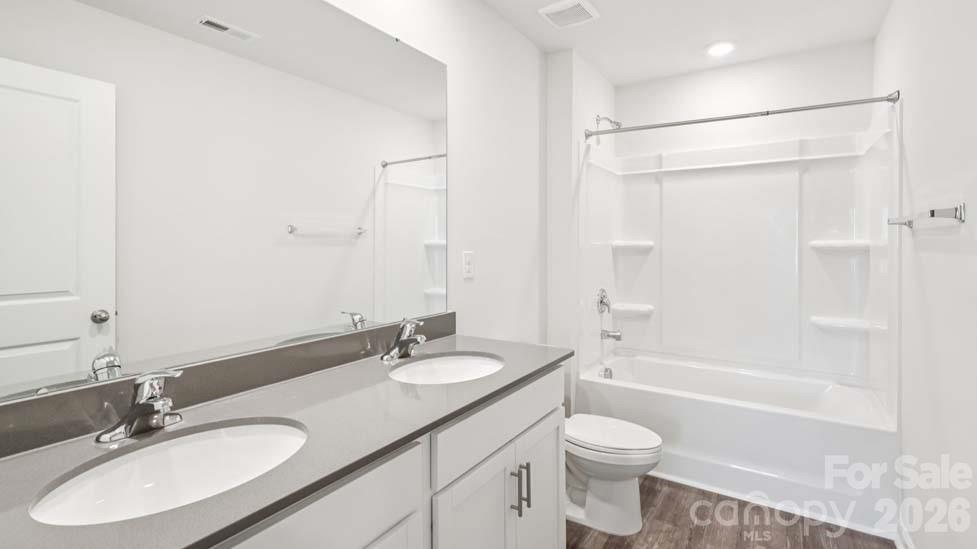 170 Old Home Road Statesville, NC 28677 - Photo 33 of 40 a bathroom with a granite countertop sink toilet a shower and a mirror