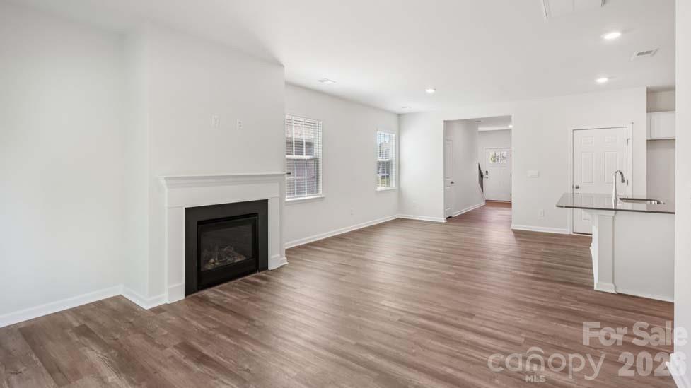 170 Old Home Road Statesville, NC 28677 - Photo 4 of 40 a view of empty room with wooden floor and fireplace