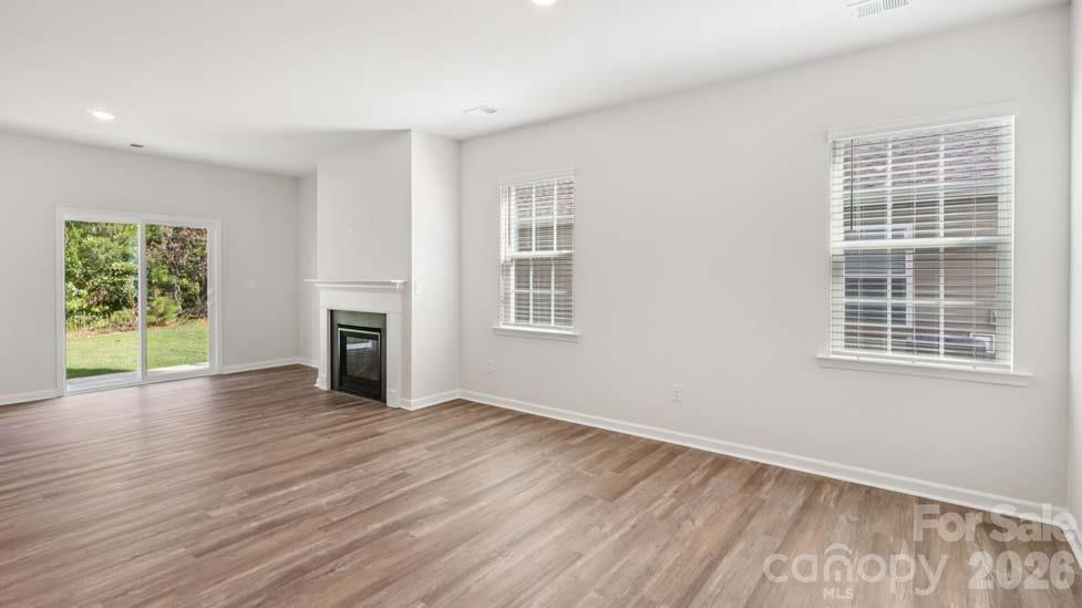 170 Old Home Road Statesville, NC 28677 - Photo 6 of 40 a view of an empty room with wooden floor and a window