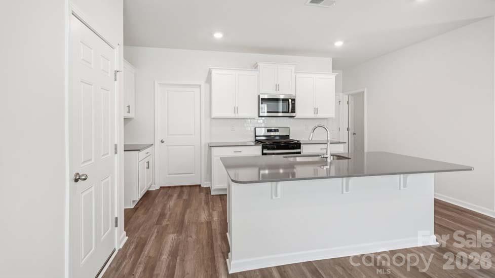 170 Old Home Road Statesville, NC 28677 - Photo 10 of 40 a kitchen with kitchen island white cabinets and stainless steel appliances