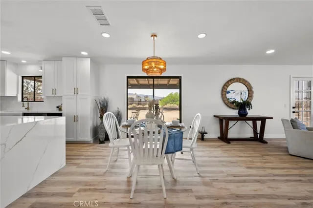 a living room with furniture a table a rug and a large window