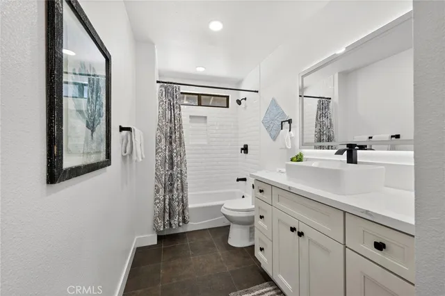 a bathroom with a double vanity sink toilet and shower