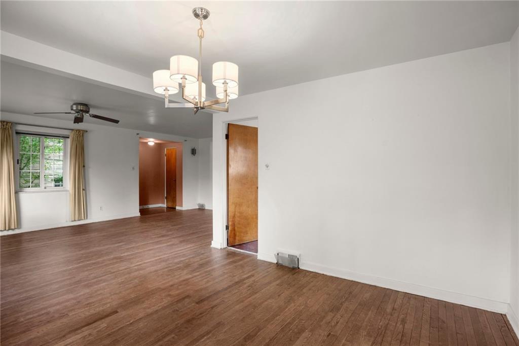 3323 Shady Ave Extension Pittsburgh, PA 15217 - Photo 12 of 45 a view of an empty room with a chandelier fan and wooden floor