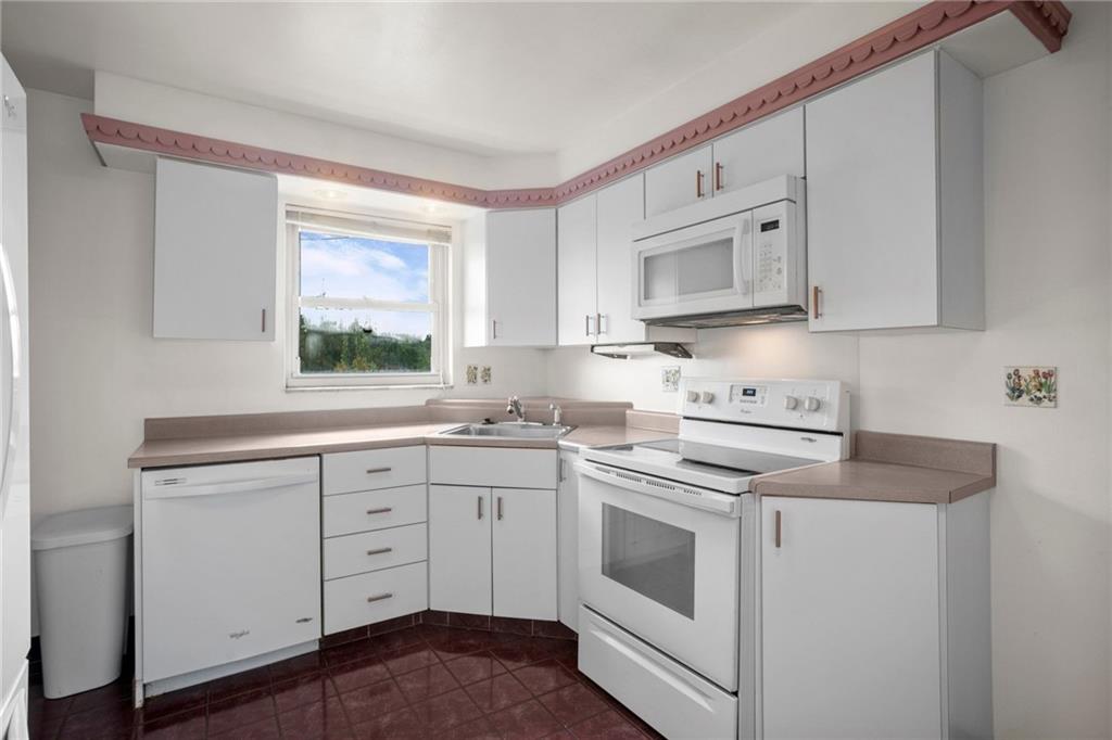 3323 Shady Ave Extension Pittsburgh, PA 15217 - Photo 15 of 45 a kitchen with cabinets appliances a sink and a window