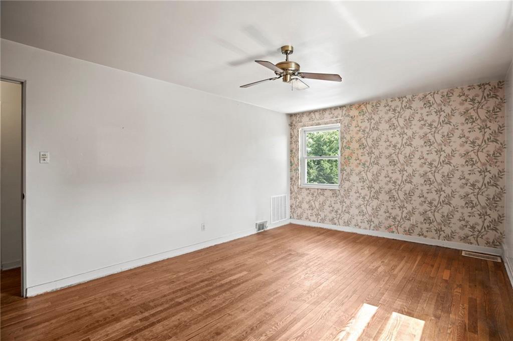 3323 Shady Ave Extension Pittsburgh, PA 15217 - Photo 20 of 45 a view of an empty room with wooden floor and a window