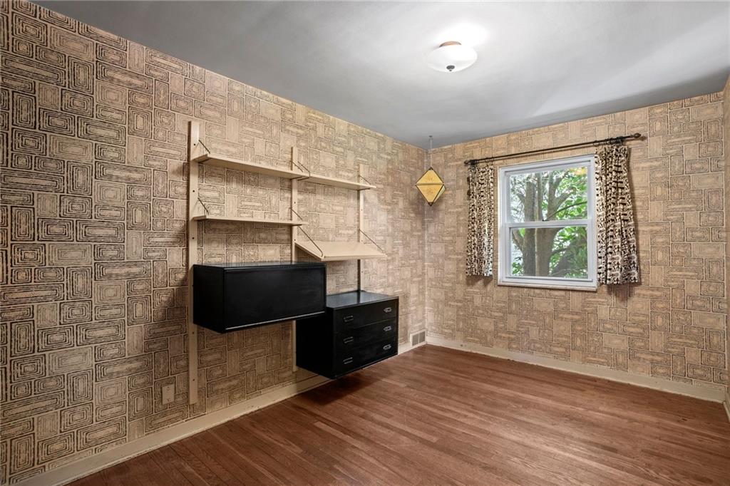 3323 Shady Ave Extension Pittsburgh, PA 15217 - Photo 24 of 45 a living room with wooden floor and a fireplace
