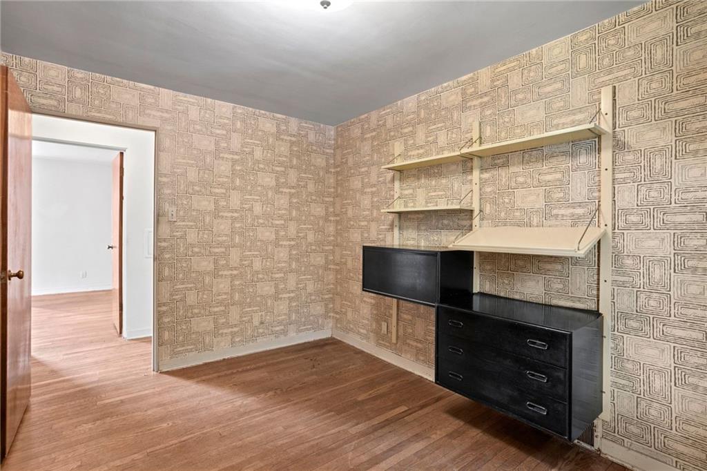 3323 Shady Ave Extension Pittsburgh, PA 15217 - Photo 26 of 45 an empty room with wooden floor and fireplace