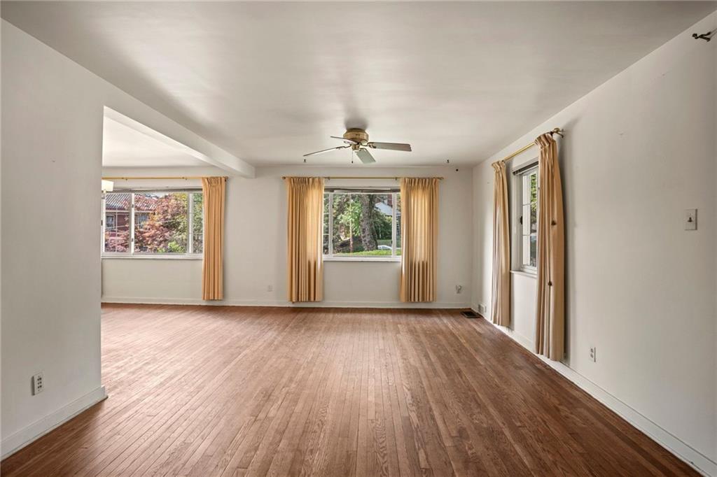 3323 Shady Ave Extension Pittsburgh, PA 15217 - Photo 9 of 45 wooden floor in an empty room with a window