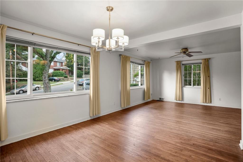 3323 Shady Ave Extension Pittsburgh, PA 15217 - Photo 10 of 45 a view of an empty room with wooden floor and a window