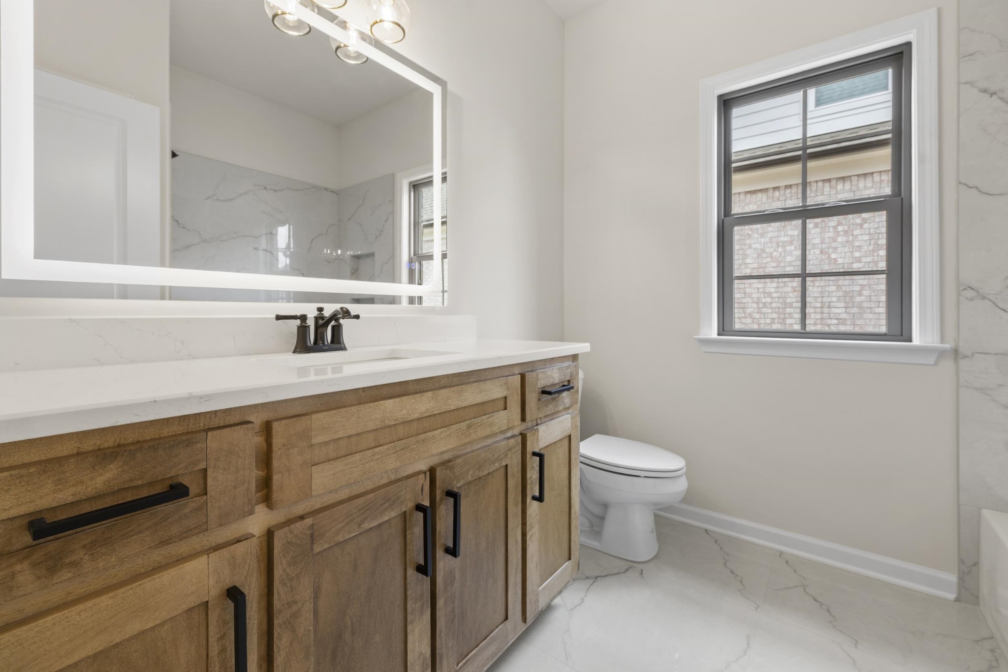 180 Oakland Rdg Cove Oakland, TN 38060 - Photo 21 of 27 a bathroom with a sink a toilet and a mirror