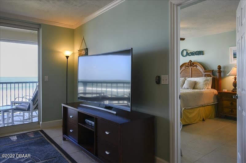 4555 South Atlantic Avenue, Unit 4207 Ponce Inlet, FL 32127 - Photo 11 of 33 a bedroom with a bed and a dresser in it