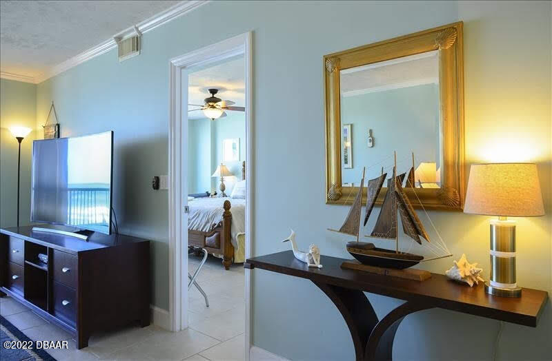 4555 South Atlantic Avenue, Unit 4207 Ponce Inlet, FL 32127 - Photo 12 of 33 a living room with furniture and a mirror