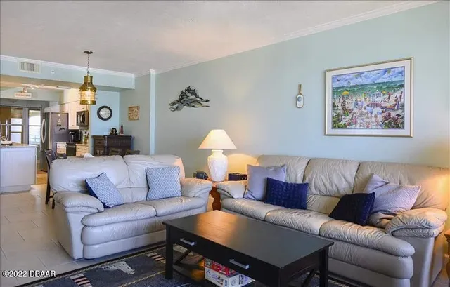 a living room with furniture and a lamp