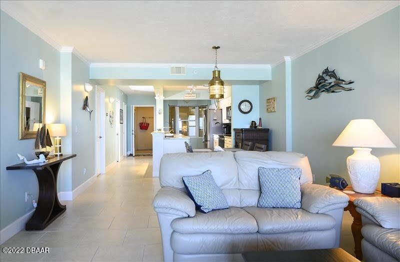 4555 South Atlantic Avenue, Unit 4207 Ponce Inlet, FL 32127 - Photo 14 of 33 a living room with furniture and a chandelier
