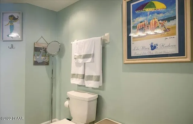 a bathroom with a toilet and a shower curtain