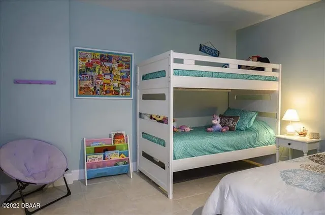 a bed room with a bed and a chair