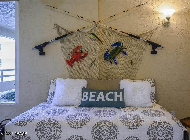 4555 South Atlantic Avenue, Unit 4207 Ponce Inlet, FL 32127 - Photo 2 of 33 a bedroom with a bed and a painting on the wall