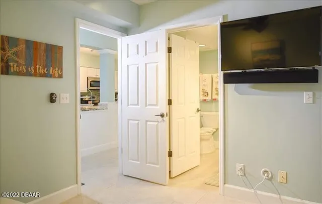 a view of a livingroom with wooden floor and cabinet