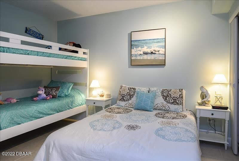 4555 South Atlantic Avenue, Unit 4207 Ponce Inlet, FL 32127 - Photo 24 of 33 a bedroom with a bed and a window