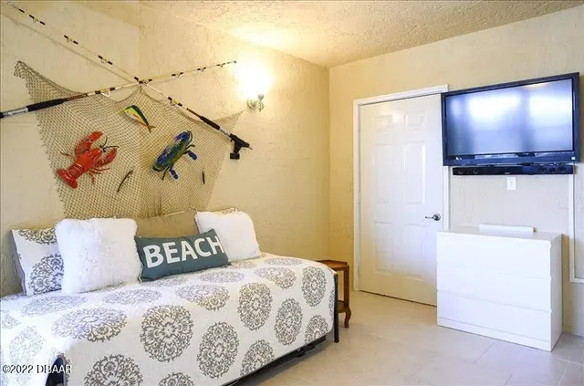 a bedroom with a bed and a flat screen tv